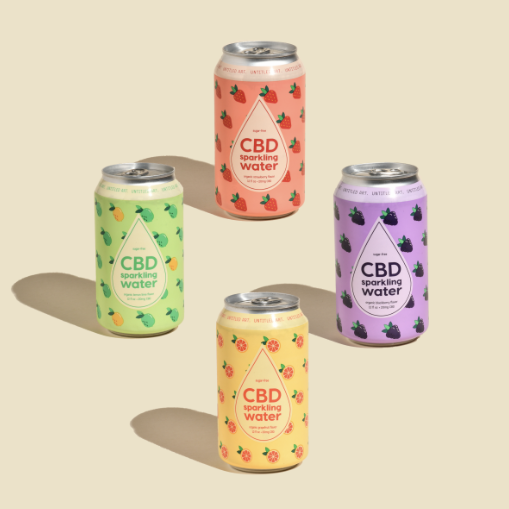 Four cans of cbd water on a beige background.