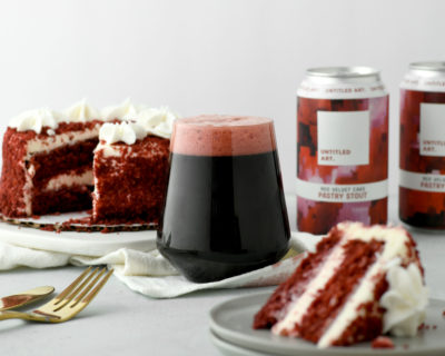 A plate with a red velvet cake and a can of beer.