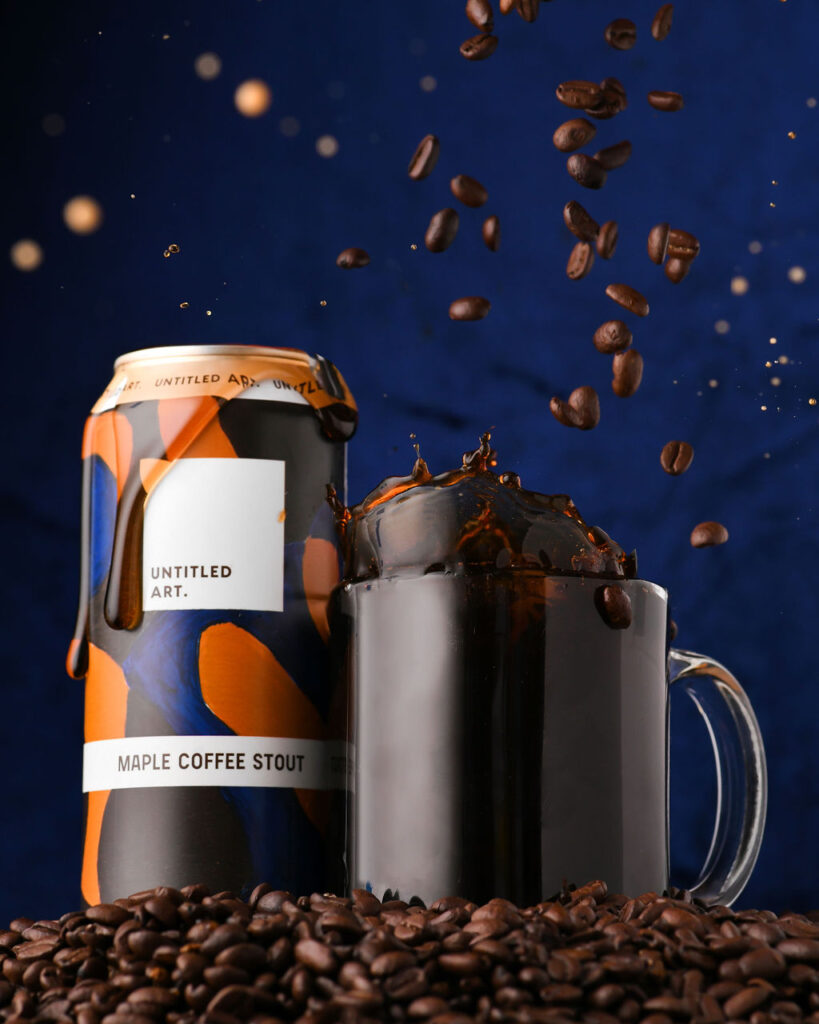 A can of coffee with coffee beans on top of it.
