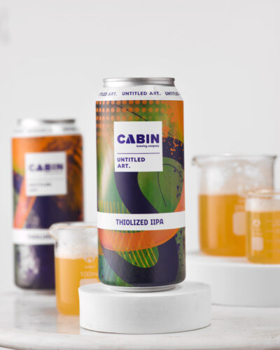 A can of cabin's twisted brew sits on a table.