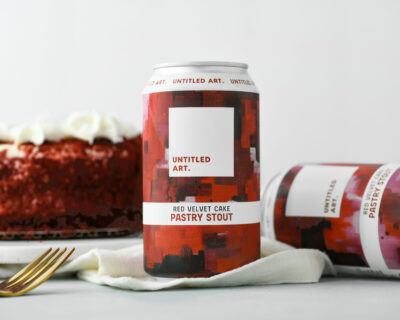 A can of red velvet cake with a fork next to it.