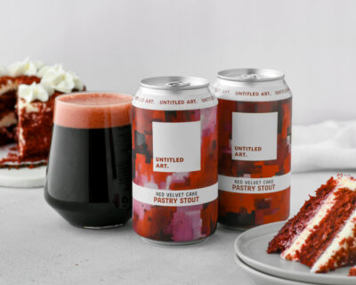 A can of red velvet beer with a slice of cake next to it.
