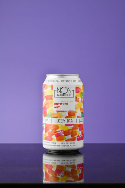 A can of iced tea sitting on top of a purple background.