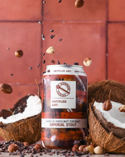 A can of beer with nuts and coconuts in it.
