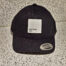 An Untitled Art Patch Logo Hat – Black with a white patch on it.