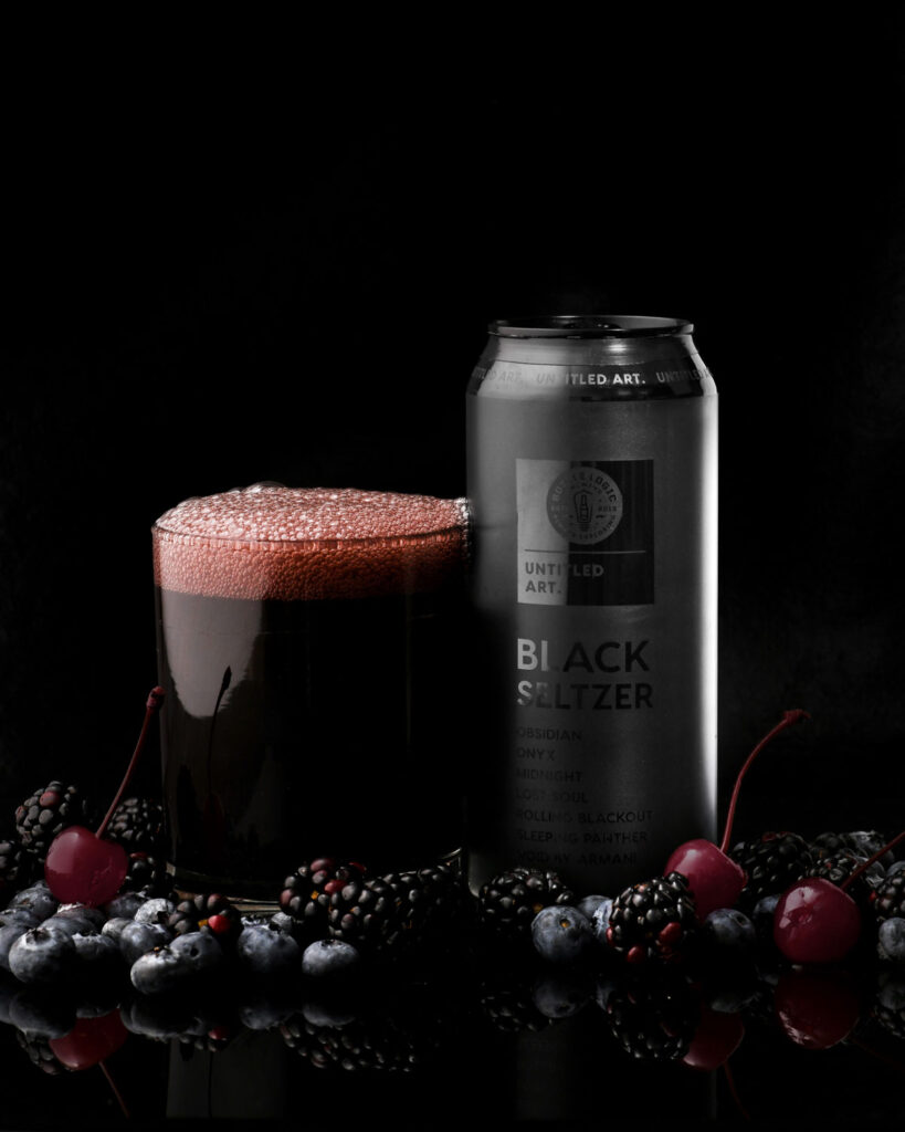 A can of black power with cherries and blackberries.