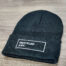 A black Untitled Art Logo Knit Cuffed Beanie with the word 'unlimited art' on it.