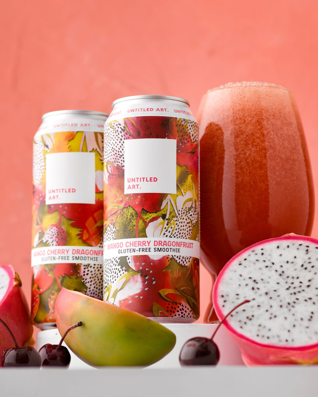 A can of dragon fruit beer and a glass of fruit.